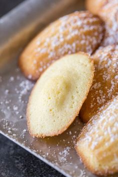 powdered sugar cookies sitting on top of a metal tray