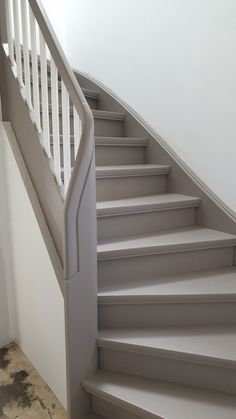 a set of stairs leading up to the top floor in a house with white walls