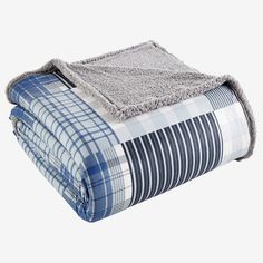 the blue and white plaid blanket is folded on top of each other, with a gray throw