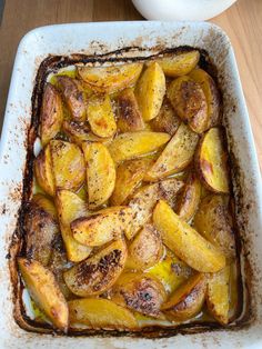 baked potatoes in a baking dish on a wooden table