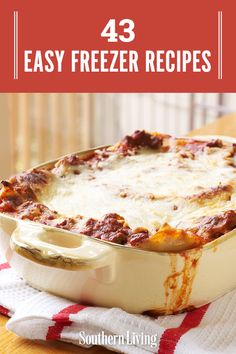 a casserole dish with cheese and sauce in it on a red and white checkered towel