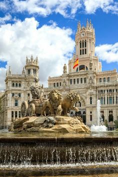 a large building with a fountain in front of it