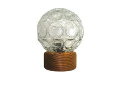 a glass ball with wooden base on a white background