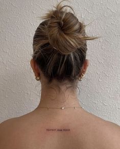 the back of a woman's neck with an inscription on it