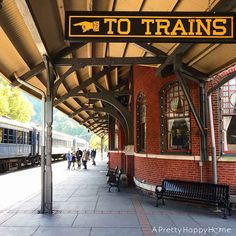 a train station with people walking on the platform