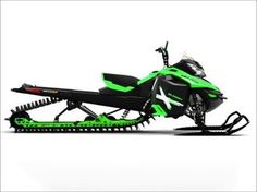 a green and black snowmobile parked on top of a white surface with skis attached to it