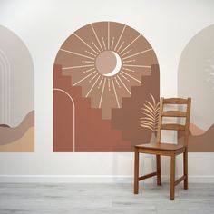 a wooden chair sitting in front of a wall mural