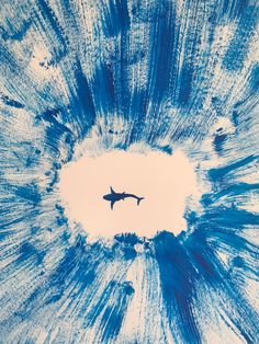 an airplane is flying in the sky above some blue and white swirly watercolors