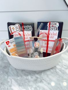 a white basket filled with lots of different items on top of a marble countertop