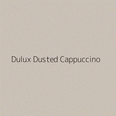 the words dulux dusted cappuccino on a gray background