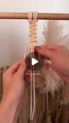 two hands are holding rope and making something