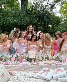 a group of young women standing around a table