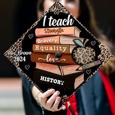 a woman holding a graduation cap that reads i teach, bravely equality love history