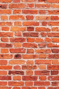 an old brick wall is shown with red bricks