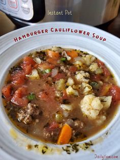 a white plate topped with soup next to an instant pot