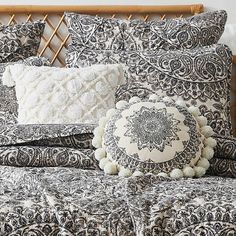 a black and white comforter with pom - poms on the pillowcase