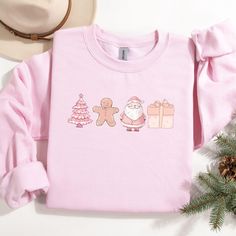 Stay cozy and festive with our Pink Christmas Tree Sweatshirt, the perfect blend of style and holiday cheer! Whether you're snuggling up by the fire or heading out for winter fun, this cute holiday crewneck adds a pop of color to your seasonal wardrobe. Available for women, kids, toddlers, and babies, it's a heartwarming gift that brings families together during the most magical time of the year. Spread the joy and make unforgettable memories this holiday season with this comfy, stylish winter p Pink Christmas Sweater, Doodles Christmas, Holiday Crewneck, Seasonal Wardrobe, Winter Pullover, Pink Christmas Tree, Holiday Sweatshirt, Winter Fun, Unforgettable Memories