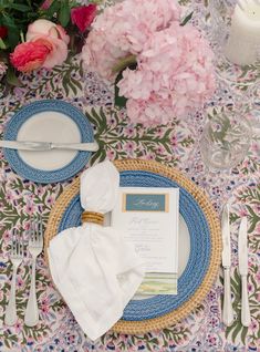 a place setting with flowers and napkins