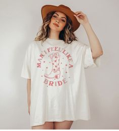 a woman wearing a cowboy hat and t - shirt