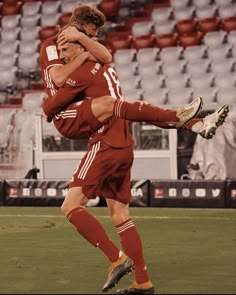 two soccer players hugging each other on the field