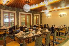 an empty restaurant with tables and chairs set up for lunch or dinner, ready to be eaten