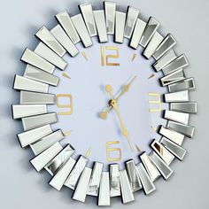 a clock that is on the side of a wall with mirrors around it's sides