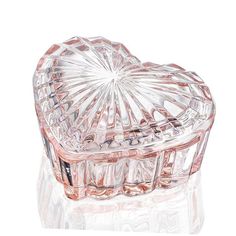 a heart shaped glass box on a white surface