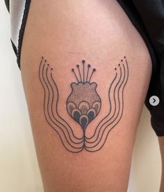 a woman's thigh with an octopus tattoo on her left leg and the word love written in black ink