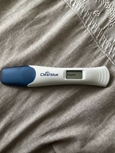 an electronic thermometer sitting on top of a bed