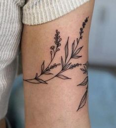 a woman's arm with a flower tattoo on the left side of her arm