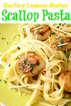 pasta with scallops and parmesan cheese on a yellow plate