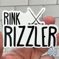 someone holding up a sticker that says rink rizzler