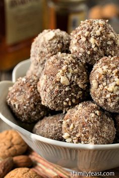 a white bowl filled with cookies and nuts