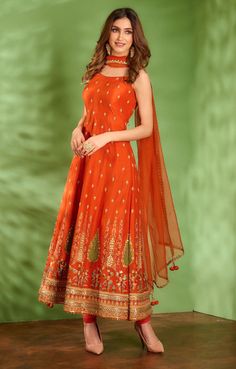 Editor's Note Featuring Tangerine Rust Anarkali Set In Dupion Silk Base With Multi-colored Floral Thread Embroidery Which Is Highlighted With Various Techniques Like Zardosi, Dabka, Sequins And... Luxury Raw Silk Anarkali Set With Mirror Work, Cheap Anarkali Banarasi Silk Blouse Piece, Luxury Chanderi Anarkali Embroidered Fabric, Luxury Cotton Anarkali Set With Mirror Work, Luxury Multicolor Anarkali Set With Dabka Work, Luxury Anarkali Chinon Embroidered Fabric, Luxury Slub Silk Anarkali Set With Chikankari Embroidery, Luxury Anarkali Blouse With Gota Work, Luxury Anarkali Blouse With Dori Work