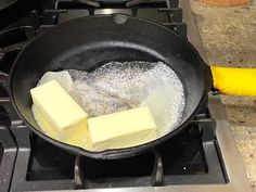 butter cubes are being cooked in a frying pan on top of the stove