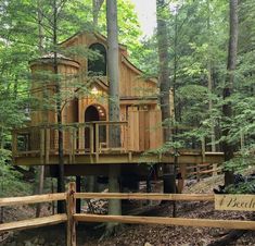 a tree house built in the woods on stilts