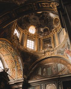 the interior of an old church with gold and white paint on the walls, windows and ceiling