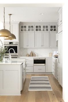 the kitchen is clean and ready for us to use it's white cabinetry