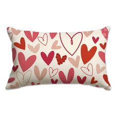 a red and pink heart pillow on a white background with hearts all over the pillow