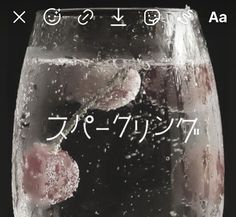 a glass filled with water and ice on top of a table