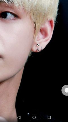 a close up of a person with ear piercings