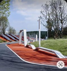 a skateboard park with ramps on the side and trees in the backgroud