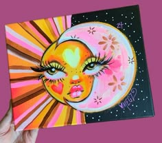 a painting of a woman's face with sun and moon in the background on a canvas