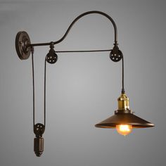 an industrial style wall light with two lights attached to it