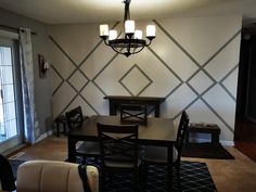 a dining room table with four chairs and a chandelier