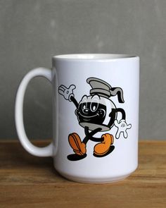 a white coffee mug with a cartoon character on it