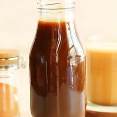 a glass jar filled with liquid sitting on top of a table