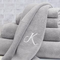 the monogrammed towels are stacked on top of each other