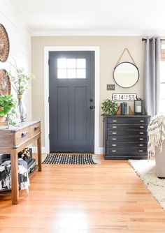 a living room filled with furniture and a black door