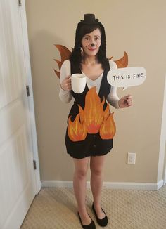 a woman in a costume holding two signs with flames on them and a cup of coffee